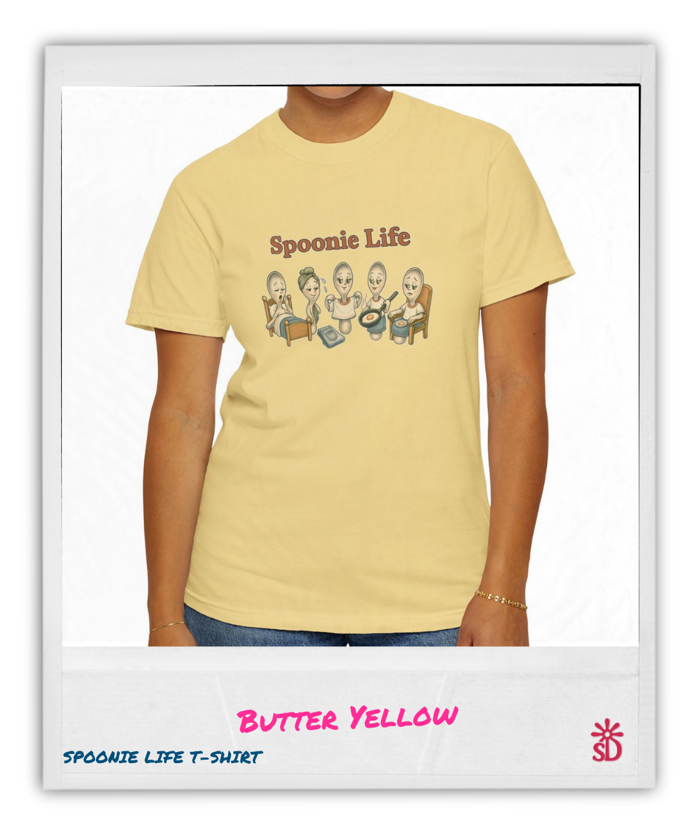 Butter yellow t-shirt with 'Spoonie Life' graphic design on a person wearing it.